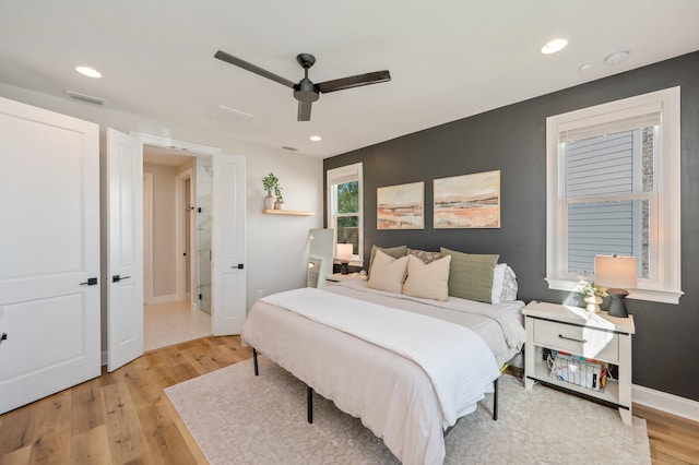 bedroom with light hardwood / wood-style flooring and ceiling fan