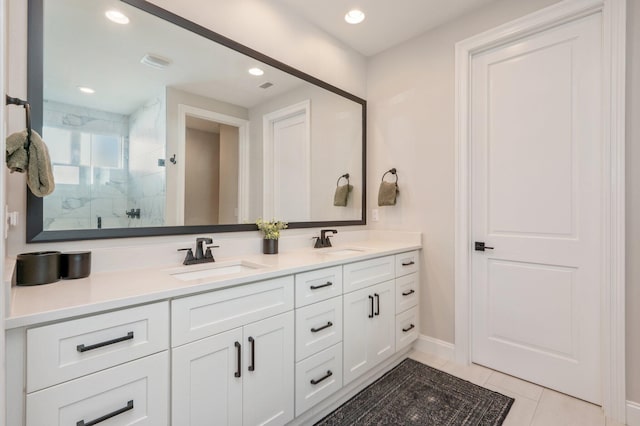 bathroom with tile patterned flooring, vanity, and a shower with door