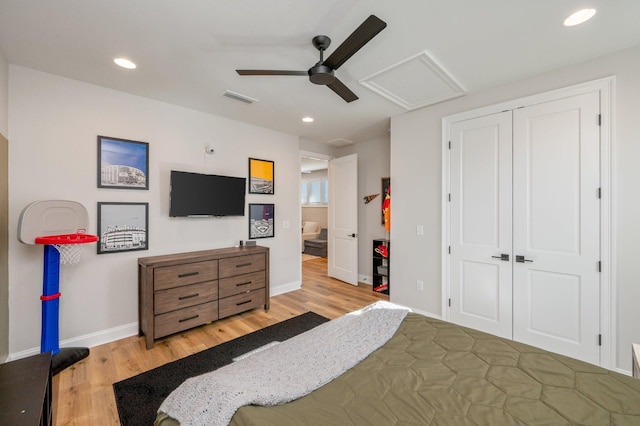 bedroom with ceiling fan, light hardwood / wood-style floors, and a closet