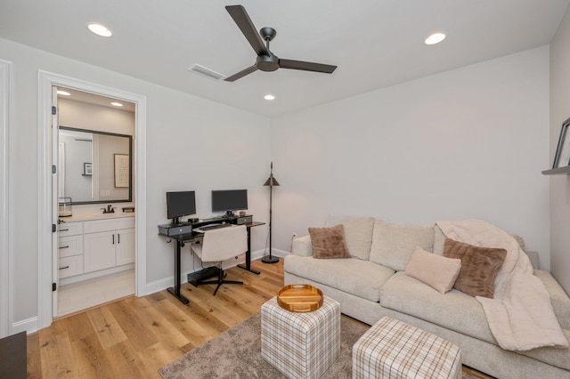 office featuring ceiling fan and light wood-type flooring