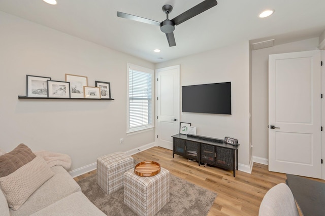 living room featuring hardwood / wood-style flooring and ceiling fan