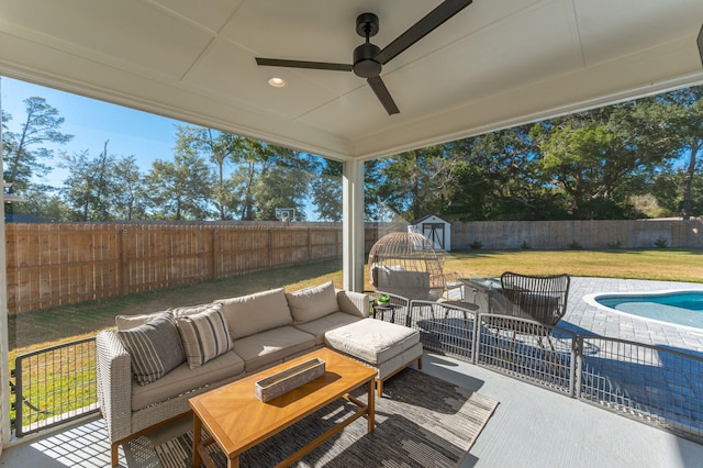 wooden deck featuring outdoor lounge area, a yard, a storage shed, and a patio area