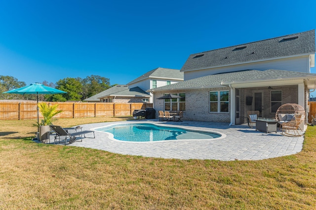 view of swimming pool featuring a yard and a patio