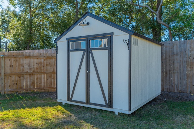 view of outdoor structure with a lawn