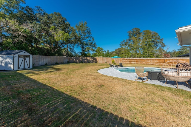 view of yard with a fenced in pool and a shed