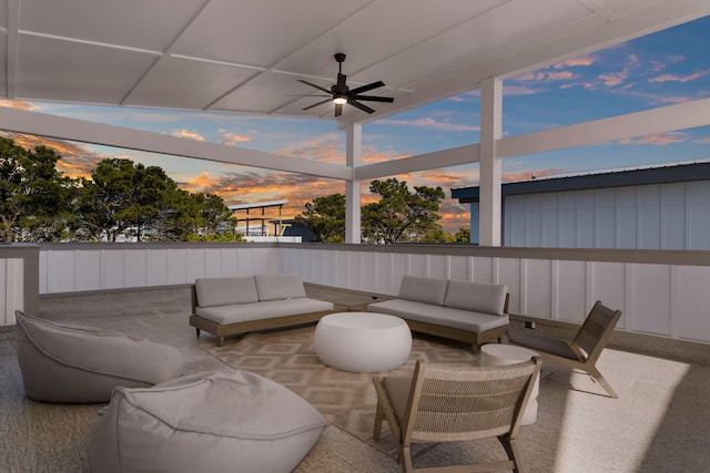 patio terrace at dusk featuring outdoor lounge area and ceiling fan