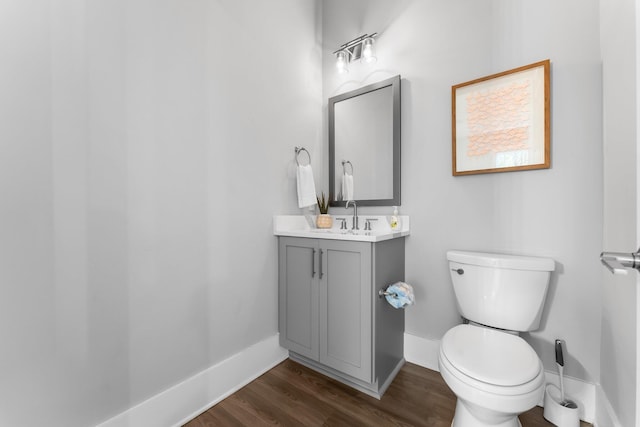 bathroom featuring vanity, toilet, and hardwood / wood-style floors