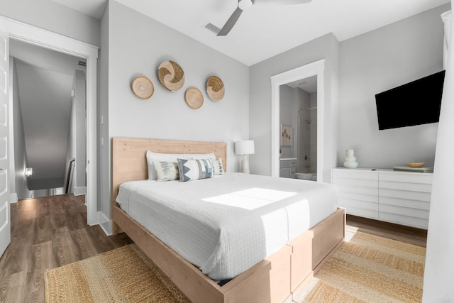 bedroom with hardwood / wood-style flooring, ceiling fan, and ensuite bathroom