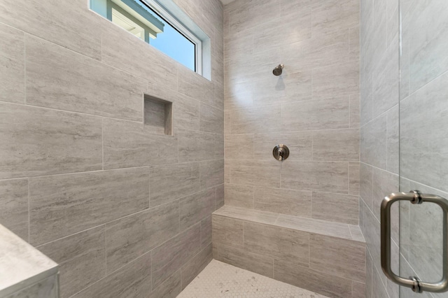 bathroom with a shower with door