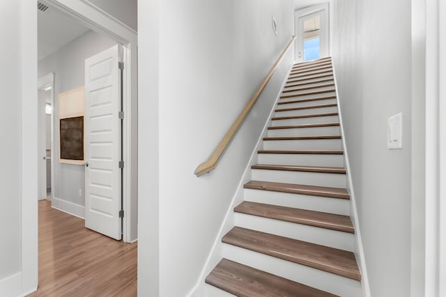 stairs featuring wood-type flooring