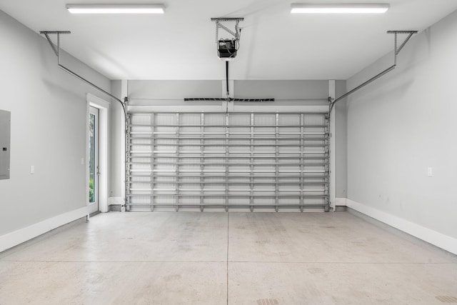 garage with a garage door opener and electric panel