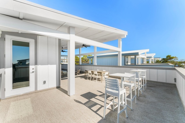 view of patio / terrace with a bar and ceiling fan