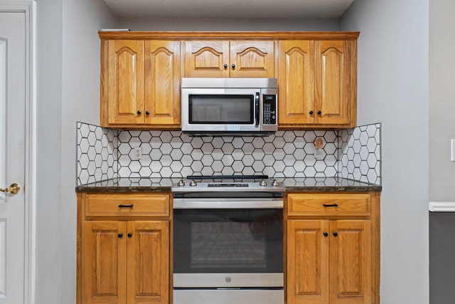 kitchen with tasteful backsplash and stainless steel appliances