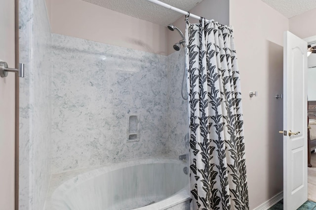 bathroom featuring shower / bath combo and a textured ceiling