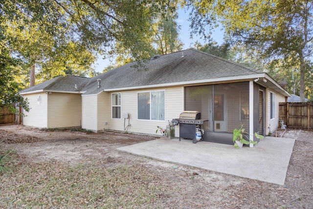 back of house with a sunroom and a patio