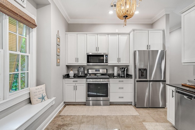 kitchen featuring appliances with stainless steel finishes, crown molding, pendant lighting, a notable chandelier, and white cabinetry