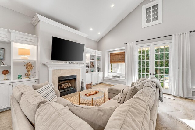 living room featuring french doors, high vaulted ceiling, and light tile patterned floors