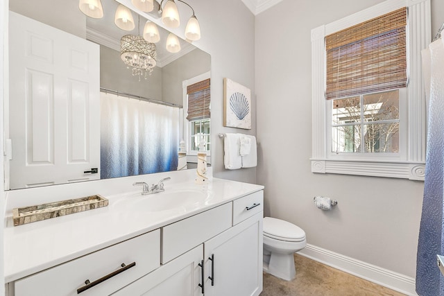 bathroom with vanity, an inviting chandelier, toilet, and crown molding