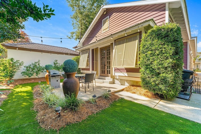 back of house with french doors, a yard, and a patio area