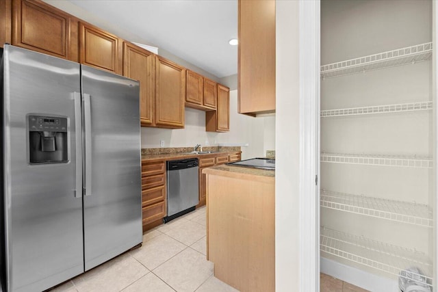 kitchen featuring sink, light tile patterned flooring, and stainless steel appliances