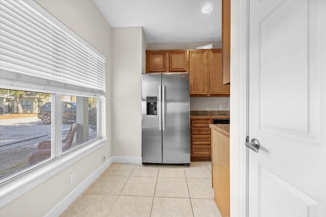 kitchen featuring stainless steel fridge and light tile patterned floors