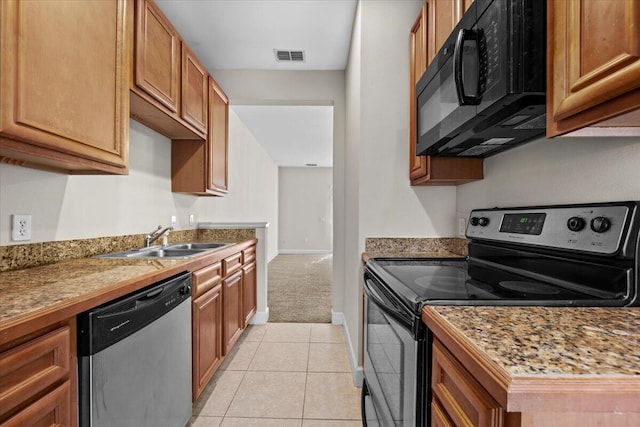 kitchen featuring light carpet, sink, and black appliances