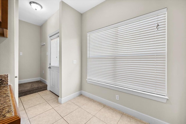 foyer entrance featuring light tile patterned flooring