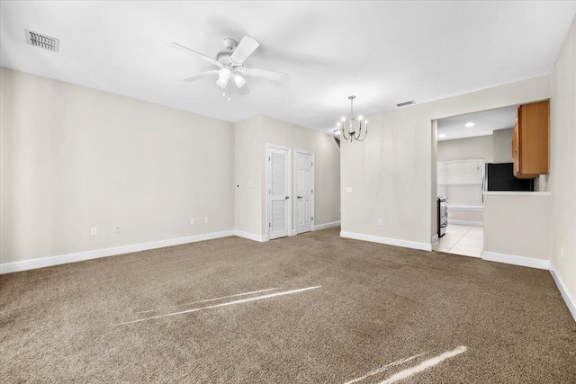 empty room with light carpet and ceiling fan with notable chandelier