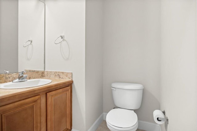 bathroom with tile patterned floors, vanity, and toilet