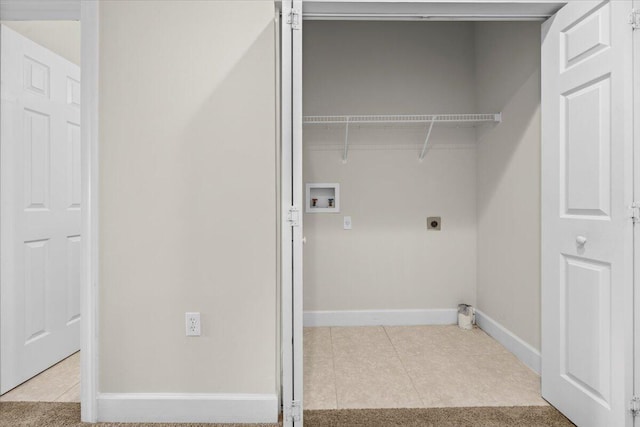 clothes washing area with hookup for an electric dryer, light tile patterned floors, and hookup for a washing machine