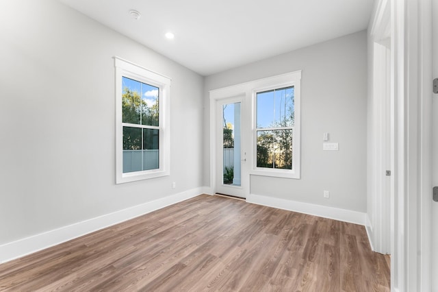 empty room with hardwood / wood-style flooring