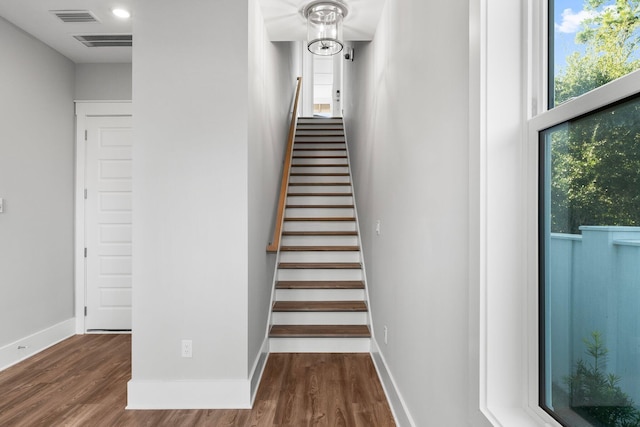 stairway featuring wood-type flooring