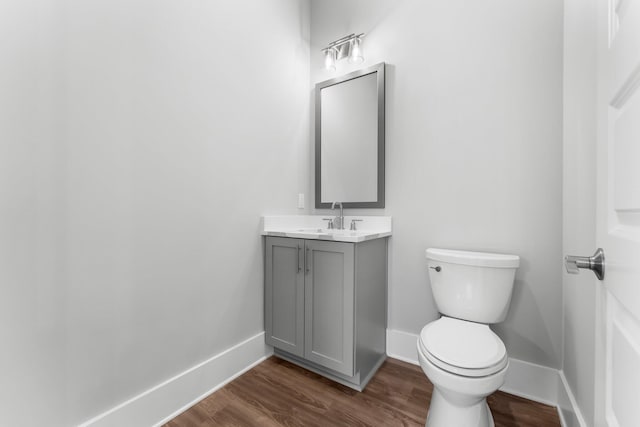 bathroom with vanity, wood-type flooring, and toilet