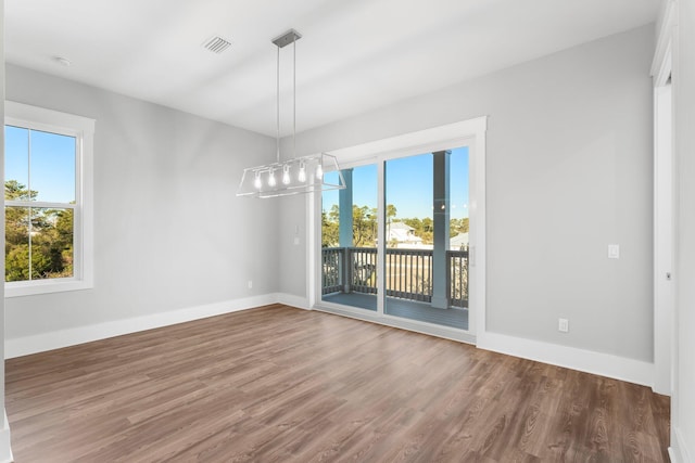 unfurnished dining area featuring dark hardwood / wood-style flooring