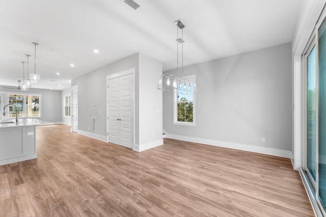 interior space with sink and light hardwood / wood-style flooring