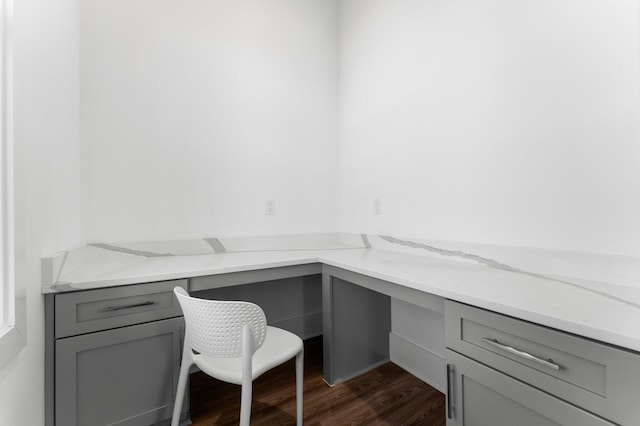 office space featuring built in desk and dark hardwood / wood-style floors