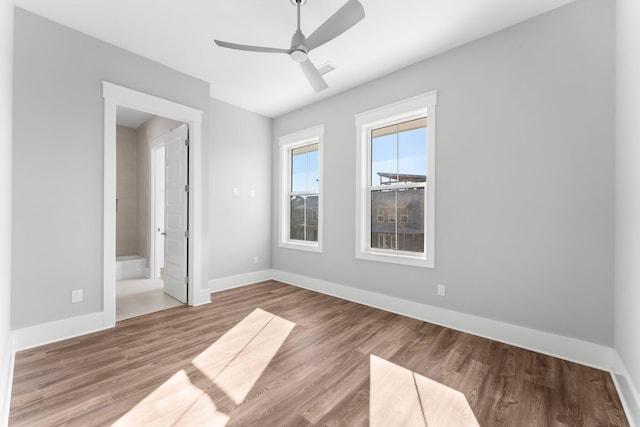 unfurnished bedroom featuring ceiling fan, hardwood / wood-style floors, and ensuite bathroom