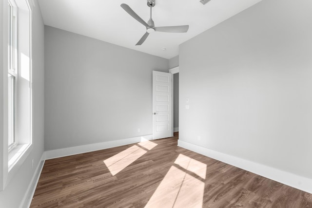 empty room featuring ceiling fan and dark wood-type flooring