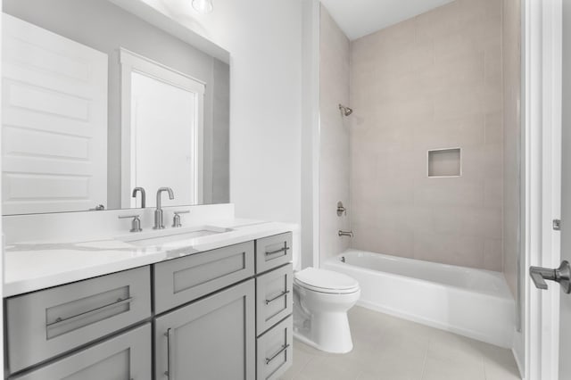 full bathroom featuring tile patterned flooring, tiled shower / bath combo, toilet, and vanity