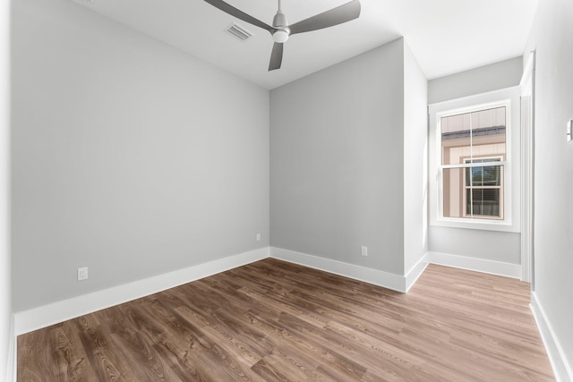 spare room with ceiling fan and wood-type flooring