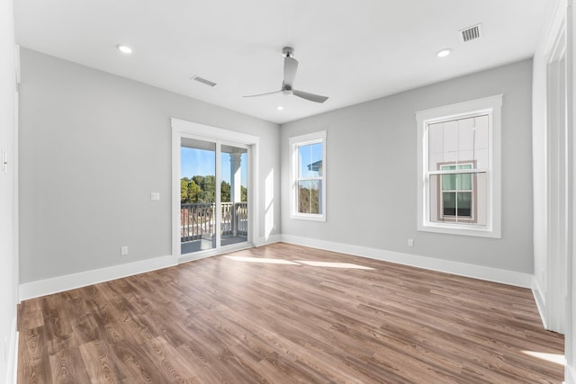 empty room with ceiling fan and hardwood / wood-style flooring