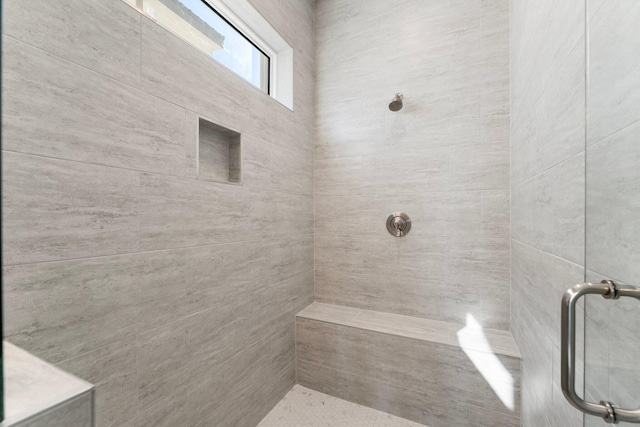 bathroom with a tile shower