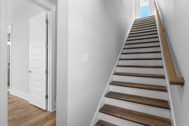 stairs with hardwood / wood-style floors