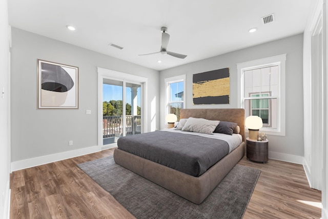 bedroom featuring hardwood / wood-style flooring, ceiling fan, and access to outside