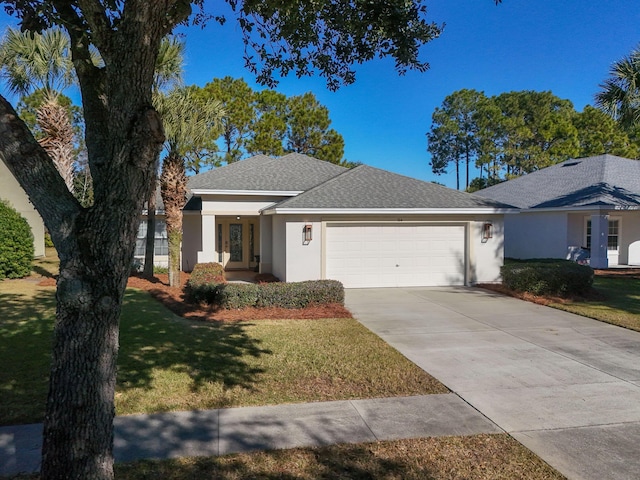 view of front of home with a front lawn and a garage