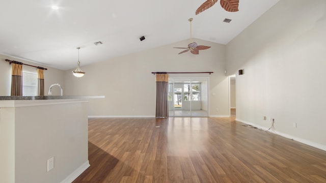 unfurnished living room with ceiling fan, dark hardwood / wood-style flooring, lofted ceiling, and sink