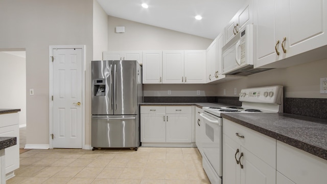 kitchen with white cabinets, light tile patterned floors, white appliances, and vaulted ceiling