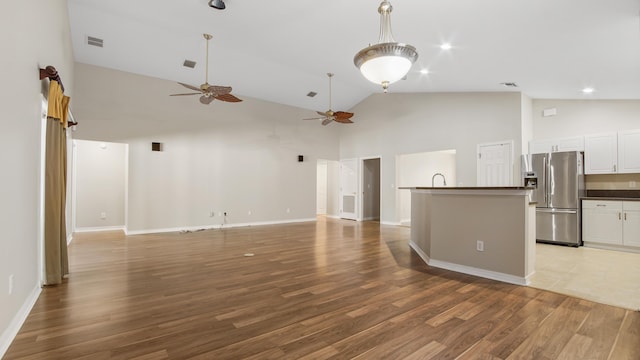 unfurnished living room featuring ceiling fan, light hardwood / wood-style floors, and high vaulted ceiling