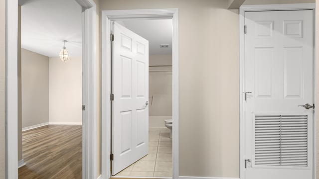 hall with light tile patterned floors