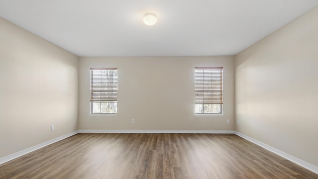 spare room with wood-type flooring